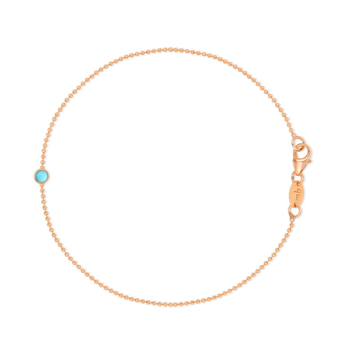 Rose gold bracelet with a turquoise gemstone on a white background