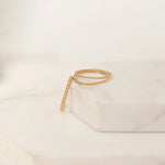 Yellow gold Delicate Trio Stacking Rings laid on a white marble surface and background. 