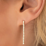 Close-up of a Down the Line Earring shown on a blonde woman's ear. 