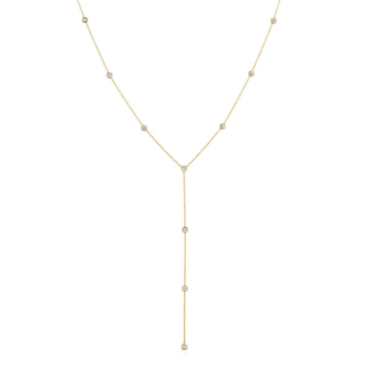 A Starstruck Diamond Lariat in yellow gold on a white background. 