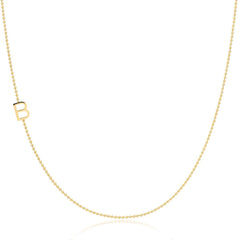 Gold beaded necklace with a 'B' charm on a white background.