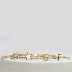 Two 14k gold Letter Rings (C and F), a Lucky Number Ring (5), a Twinkle Twinkle Ring and a Birthstone Ring, against a light grey background.
