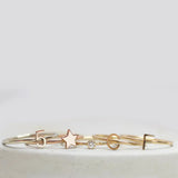 Five gold rings, including two Letter Rings (C and F), a Number 5 Ring, a Twinkle Twinkle Ring and a Birthstone Ring.