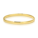 A gold vermeil For Keeps Bangle on a white background. 