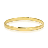 A gold vermeil For Keeps Bangle on a white background. 