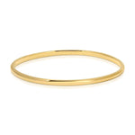 A vermeil gold Flirt Bangle on a white background. 
