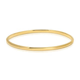 A vermeil gold Flirt Bangle on a white background. 