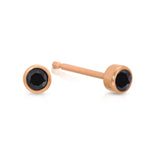 A pair of Birthstone Studs - Onyx (August) in rose gold on a white background.