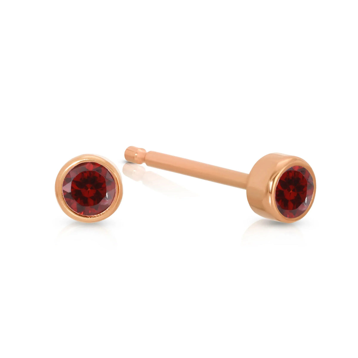 A pair of Birthstone Studs - Garnet (January) in rose gold on a white background.