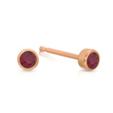 A pair of Birthstone Studs - Ruby (July) in rose gold on a white background.