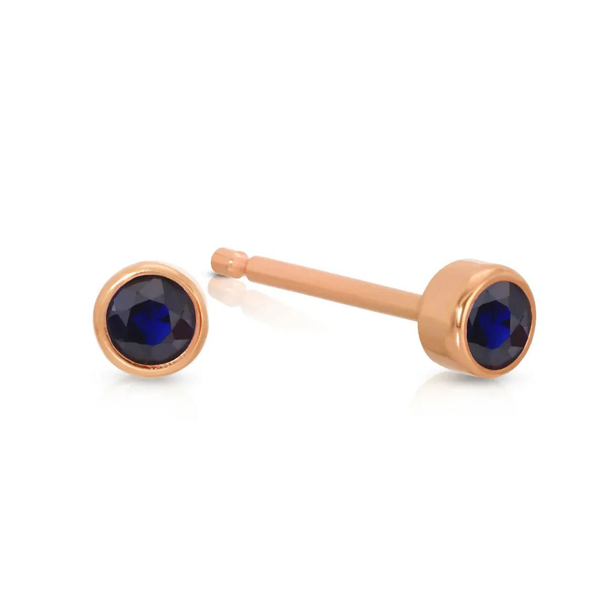 A pair of Birthstone Studs - Sapphire (September) in rose gold on a white background.