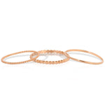 Delicate Trio Stacking Rings in rose gold on a white background. 