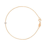 A rose gold Birthstone Bracelet with a cable chain and a diamond birthstone on a white background.