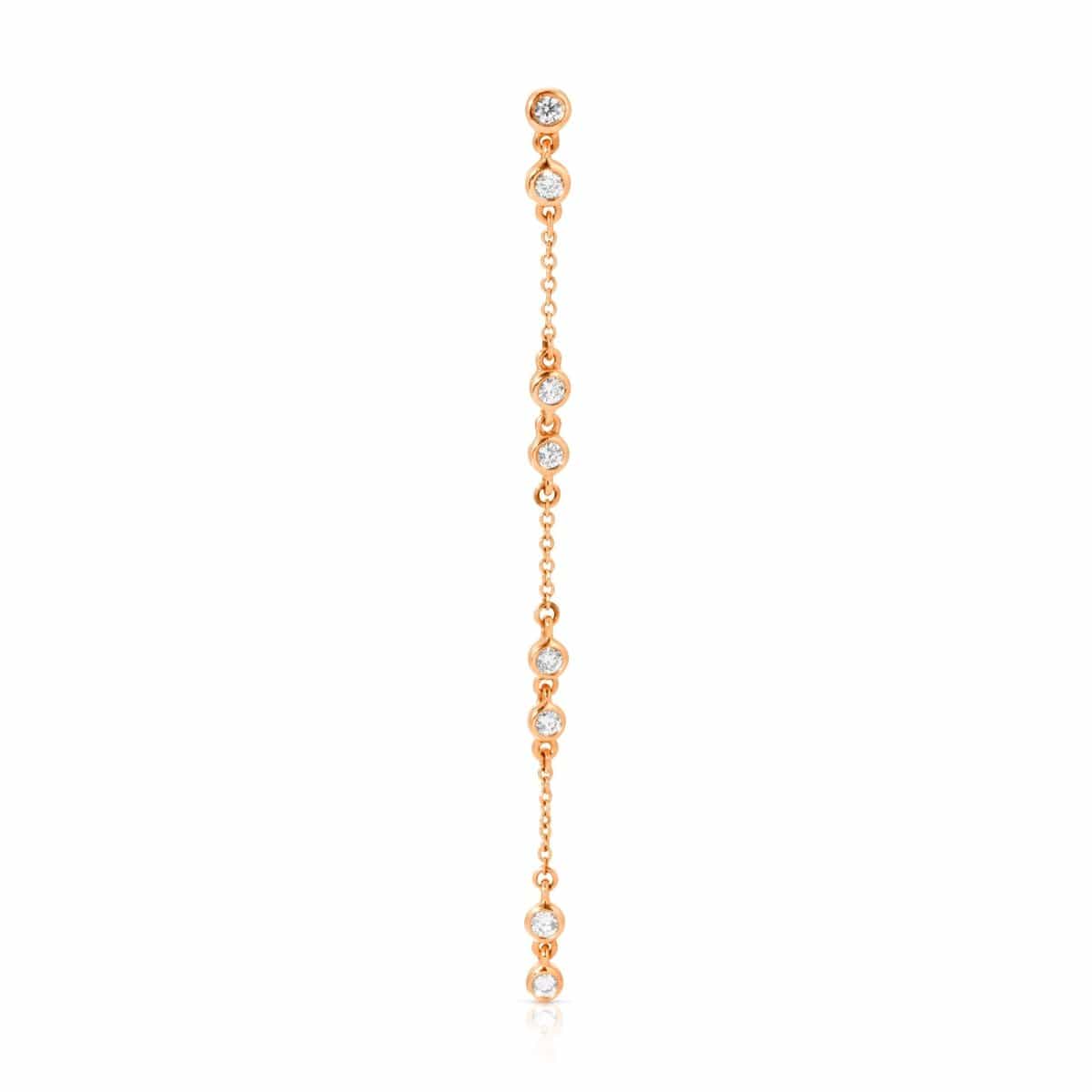 A Stardust Earring in rose gold on a white background. 