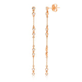 A pair of Stardust Earrings in rose gold on a white background. 