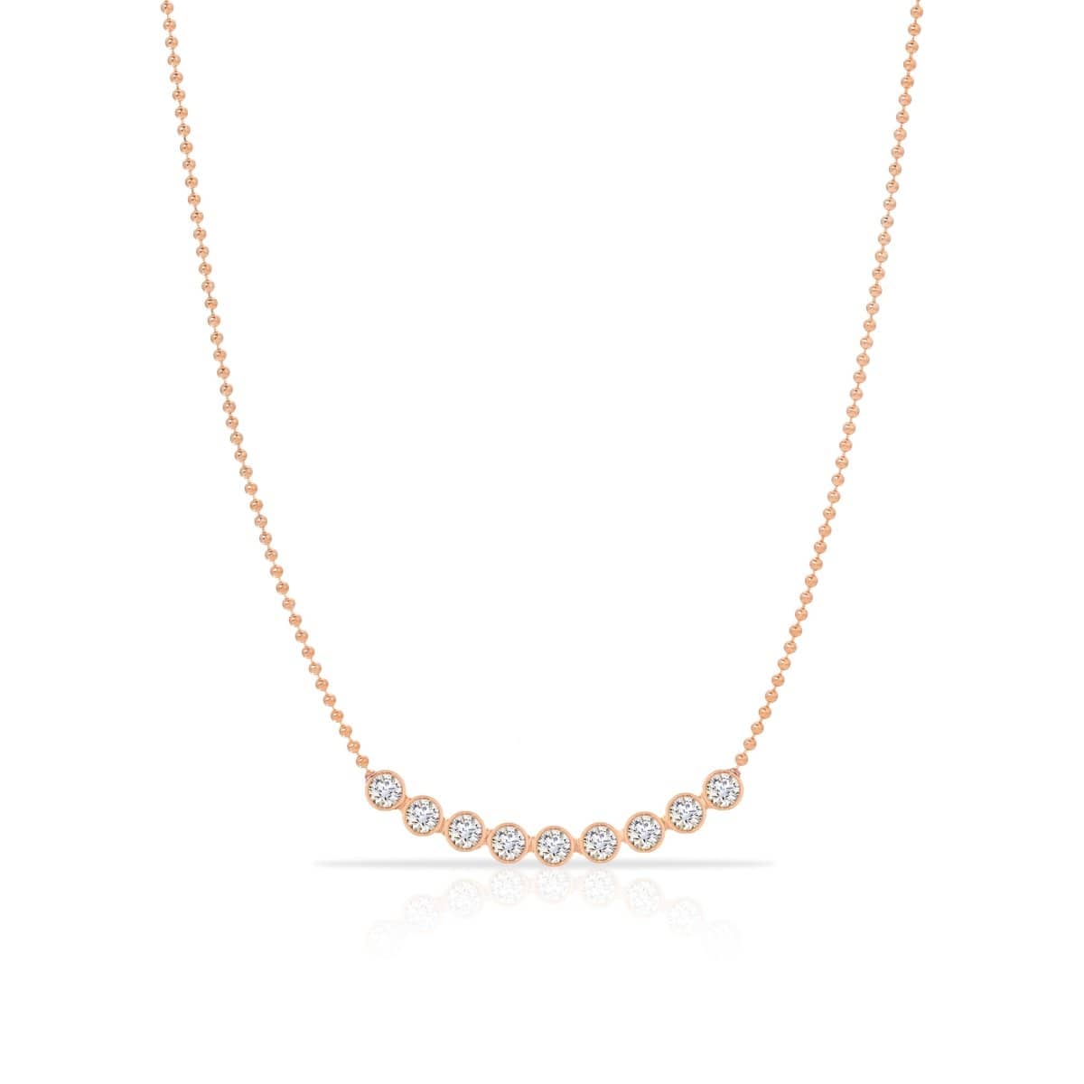 A Diamond Arc Layering Necklace in rose gold on a white background. 