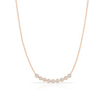 A Diamond Arc Layering Necklace in rose gold on a white background. 
