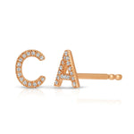Rose gold pave earrings with C and A letters on a white background. 