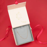 A Pavé Monogram Necklace with Diamond and a letter A charm in rose gold in a Maya Brenner jewellery box. 