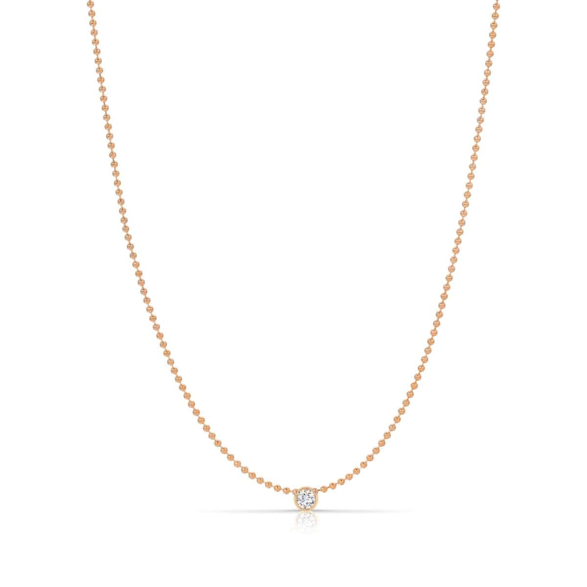 A Single Diamond Layering Necklace in rose gold on a white background. 