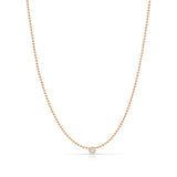 A Single Diamond Layering Necklace in rose gold on a white background. 