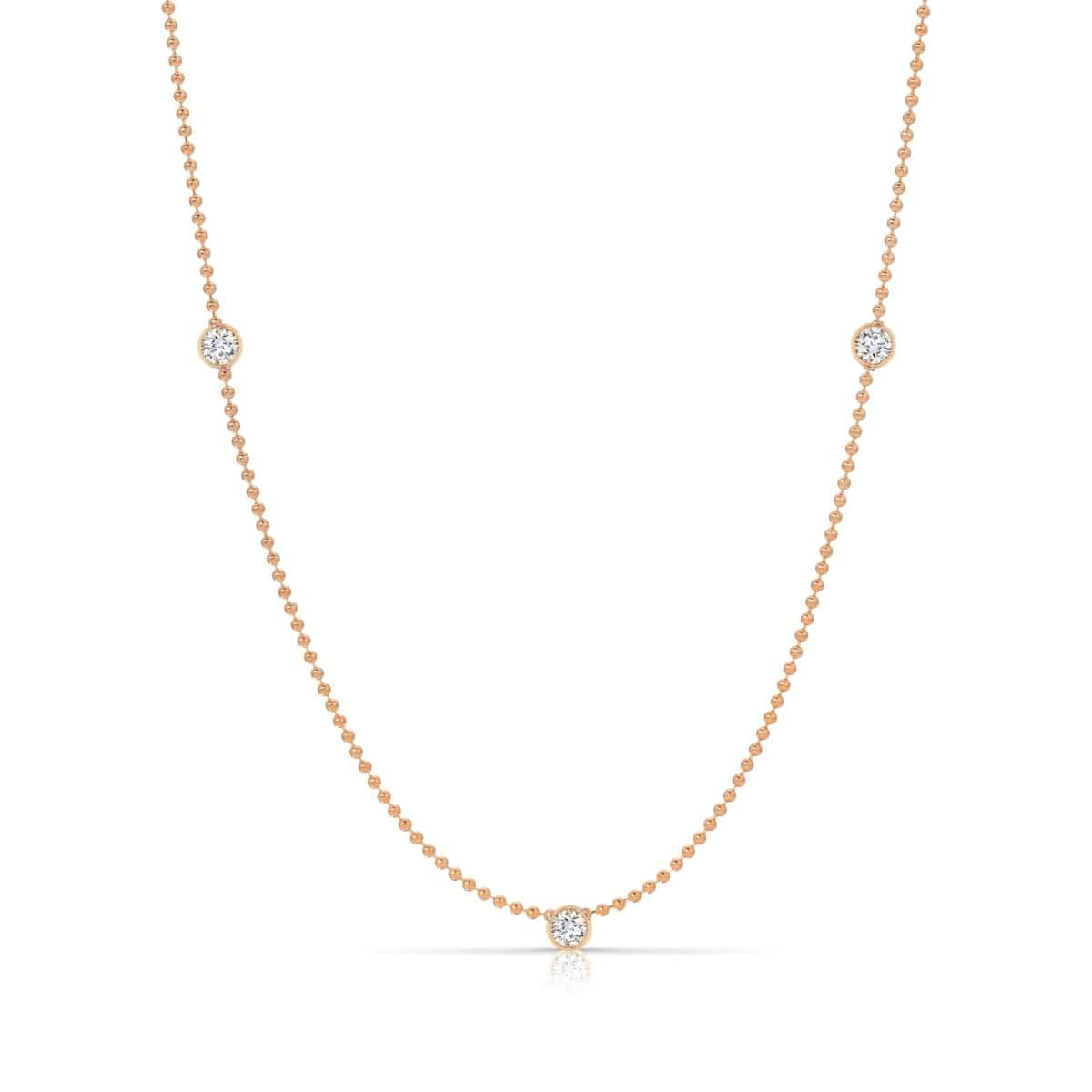 Triple Diamond Layering Necklace in rose gold on a white background. 