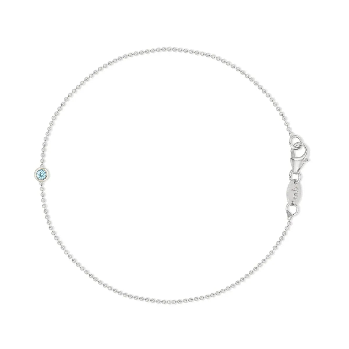 A white gold Birthstone Bracelet with a beaded chain and an aquamarine birthstone on a white background.