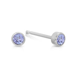 A pair of Birthstone Studs - Tanzanite (December) in white gold on a white background.