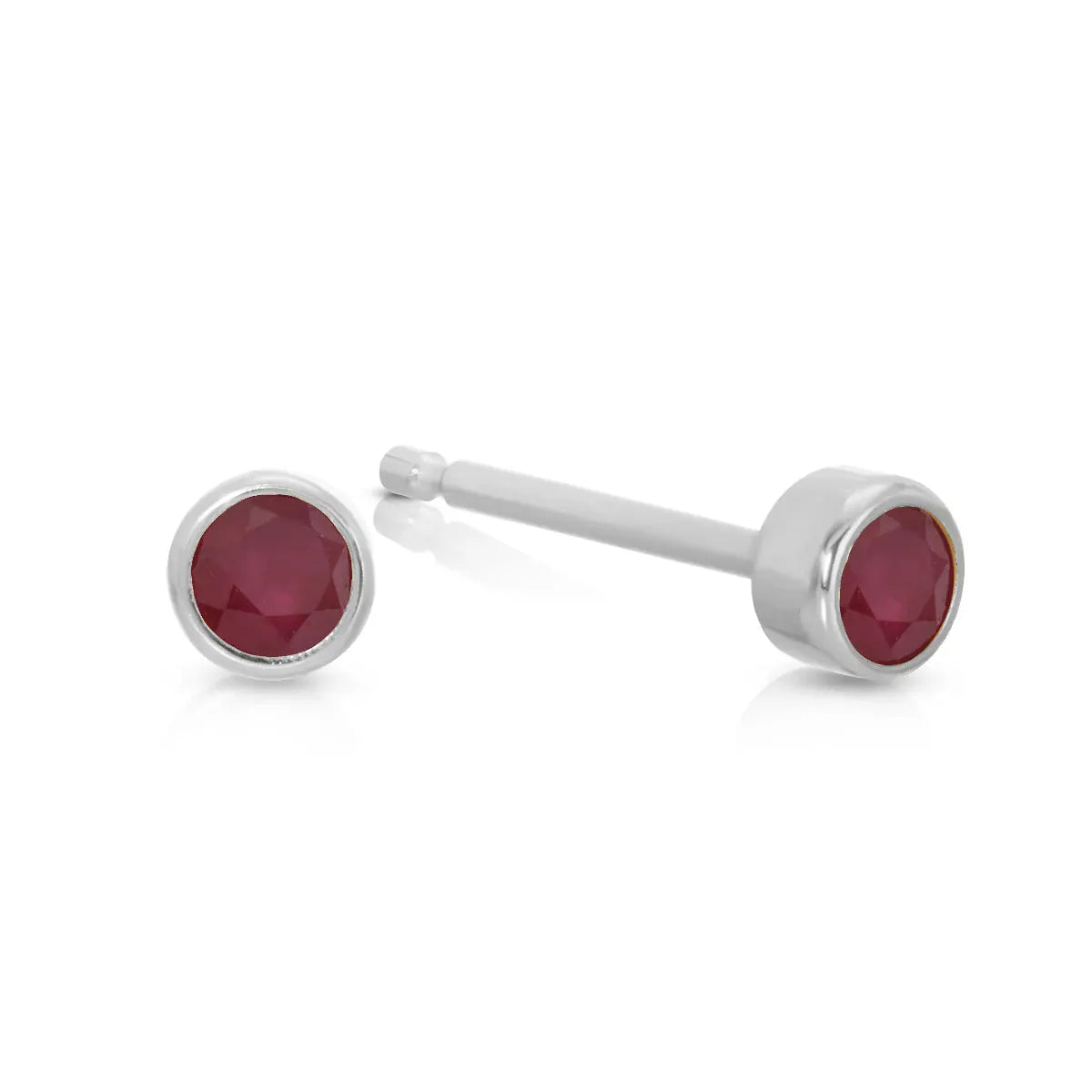 A pair of Birthstone Studs - Ruby (July) in white gold on a white background.