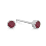 A pair of Birthstone Studs - Ruby (July) in white gold on a white background.