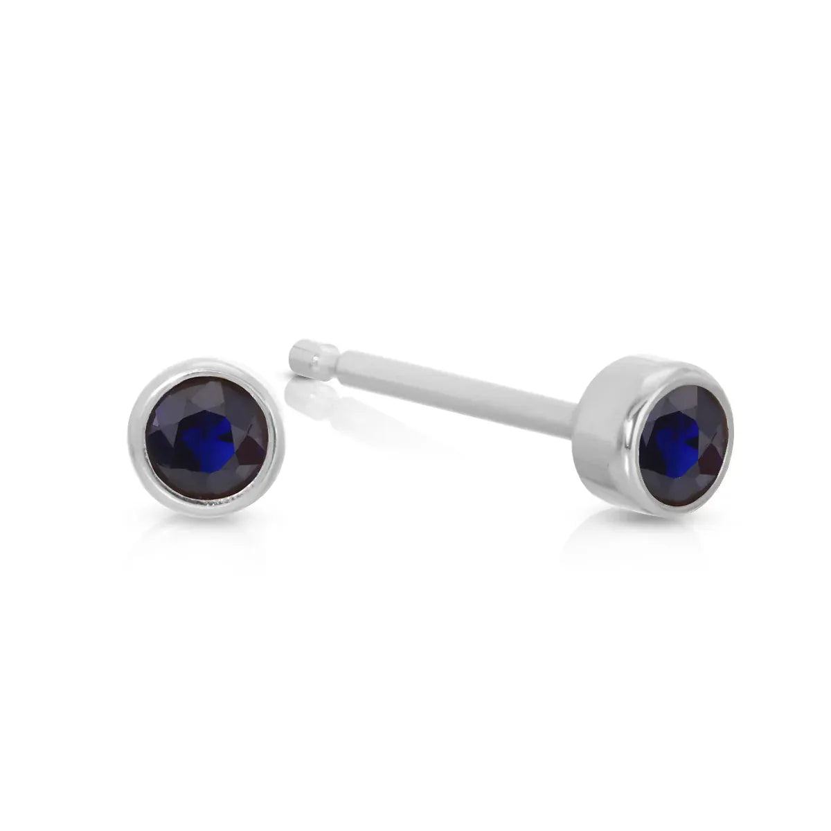 A pair of Birthstone Studs - Sapphire (September) in white gold on a white background.
