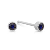A pair of Birthstone Studs - Sapphire (September) in white gold on a white background.