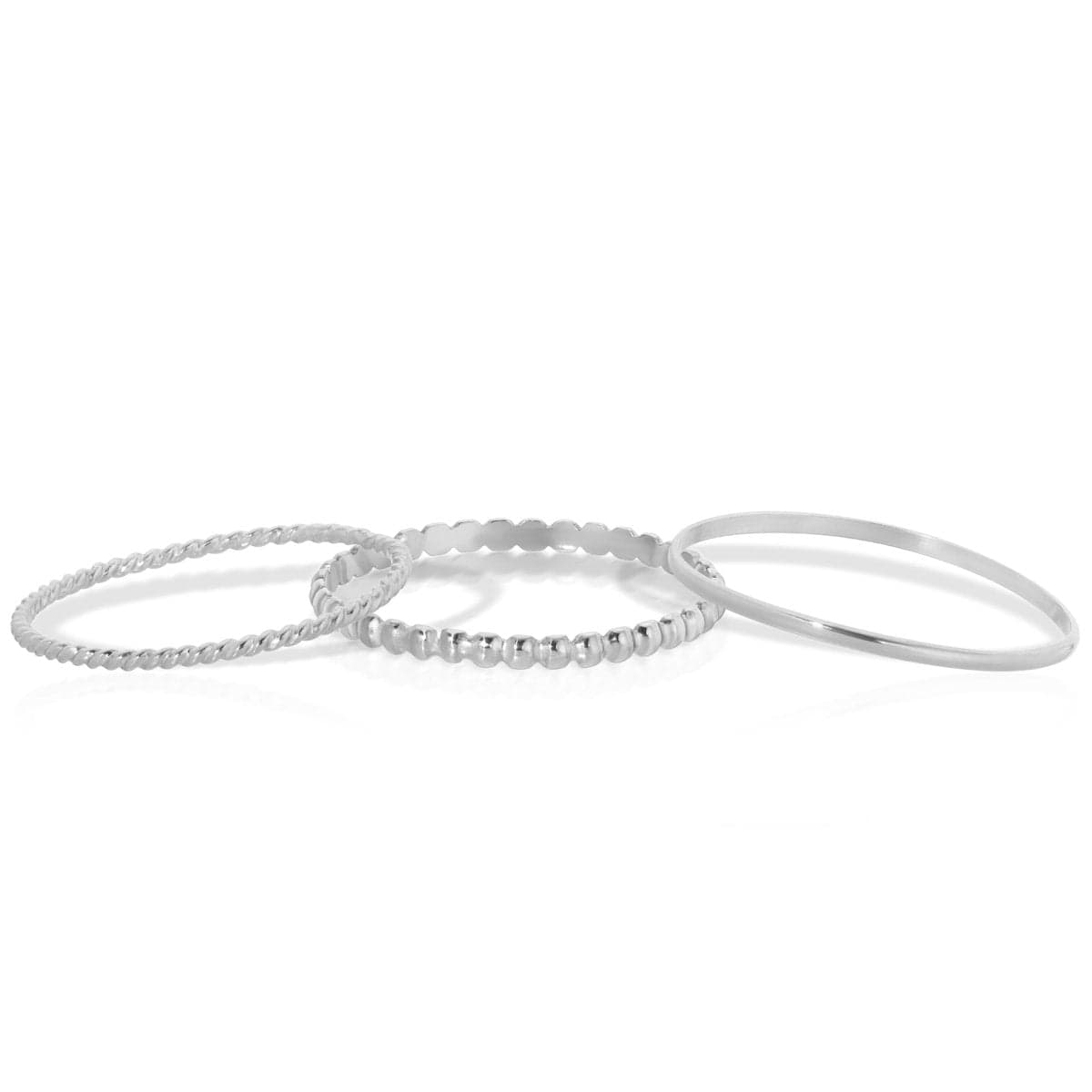 Delicate Trio Stacking Rings in white gold on a white background. 