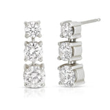 A pair of Triple Sec Diamond Earrings in white gold on a white background. 