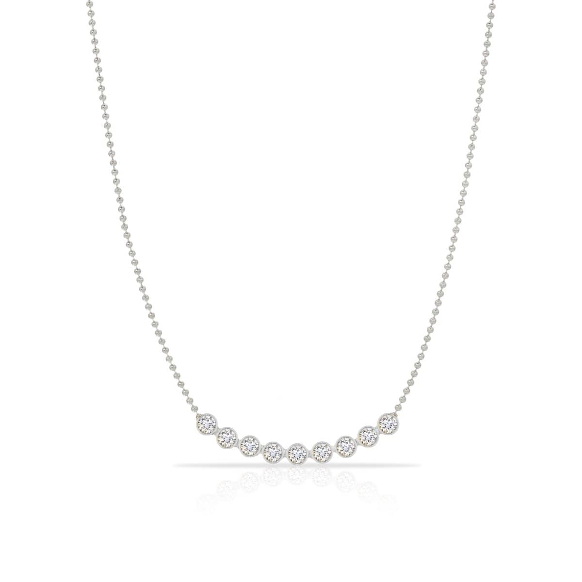 A Diamond Arc Layering Necklace in white gold on a white background. 