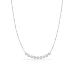 A Diamond Arc Layering Necklace in white gold on a white background. 