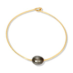 A Baroque Black Pearl Bangle on a white background. 