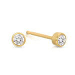 A pair of Birthstone Studs - Diamond (April) in yellow gold on a white background.