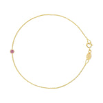 A yellow gold Birthstone Bracelet with a cable chain and pink tourmaline birthstone on a white background. 