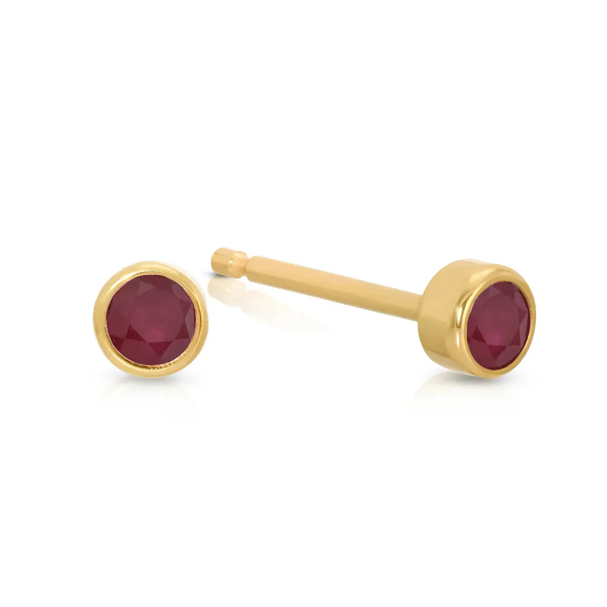 A pair of Birthstone Studs - Ruby (July) in yellow gold on a white background.