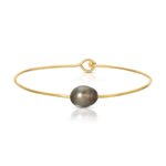A Baroque Black Pearl Bangle on a white background. 