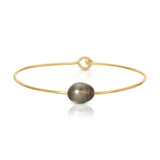 A Baroque Black Pearl Bangle on a white background. 