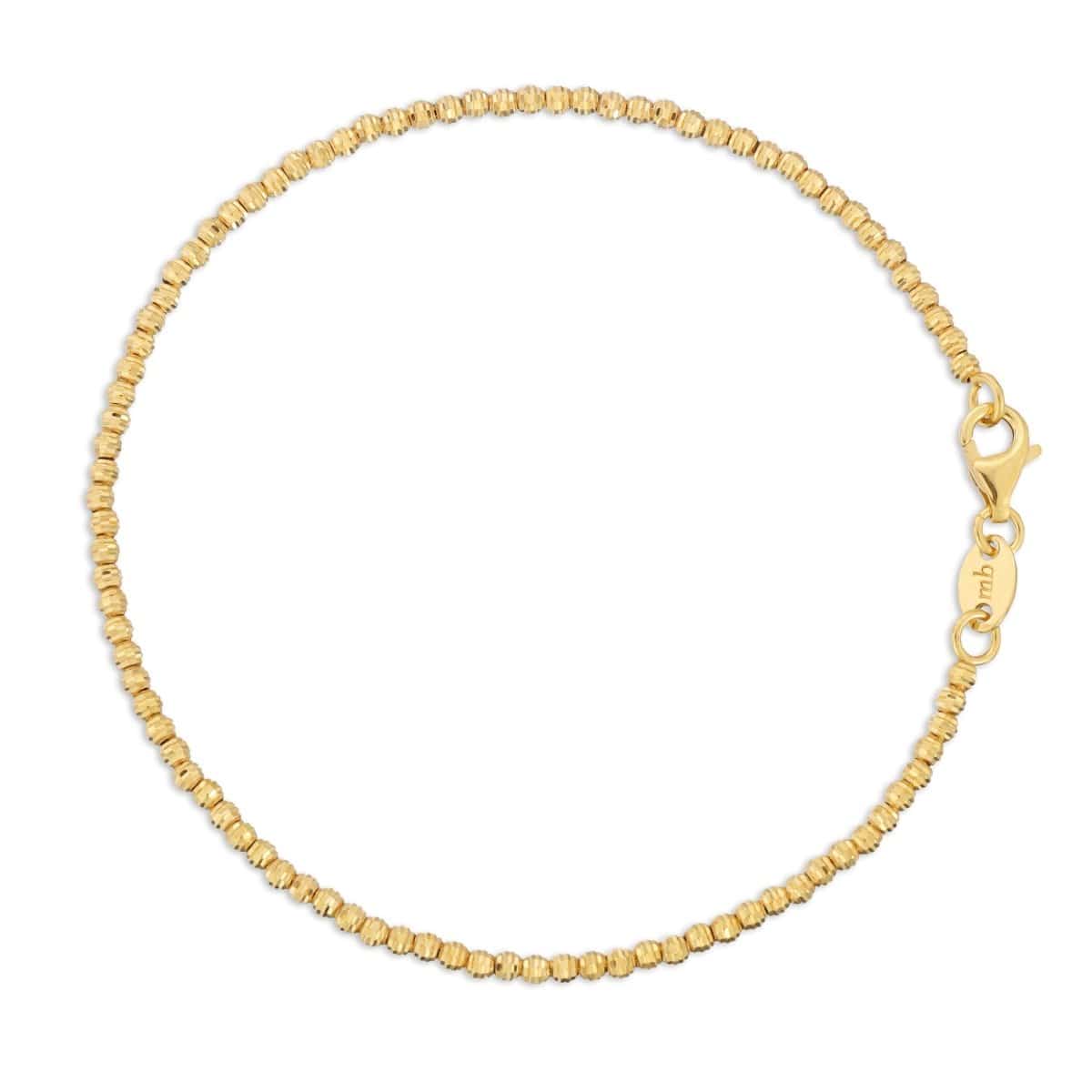 A Diamond Cut Bracelet in yellow gold on a white background. 
