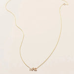 A MRS Necklace in yellow gold on a cable chain on a white background. 