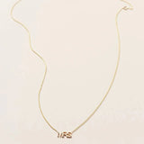 A MRS Necklace in yellow gold on a cable chain on a white background. 