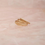 Delicate Trio Stacking Rings on a light pink marble background. 