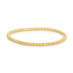 A Delicate Twist Band in yellow gold on a white background. 