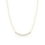 A Diamond Arc Layering Necklace in yellow gold on a white background. 