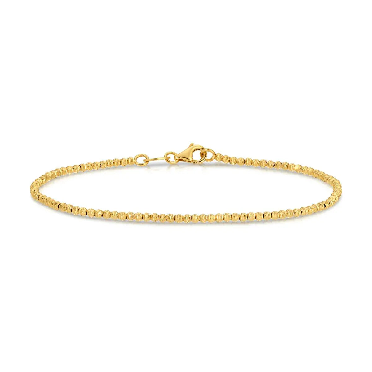 A Diamond Cut Bracelet in yellow gold on a white background. 