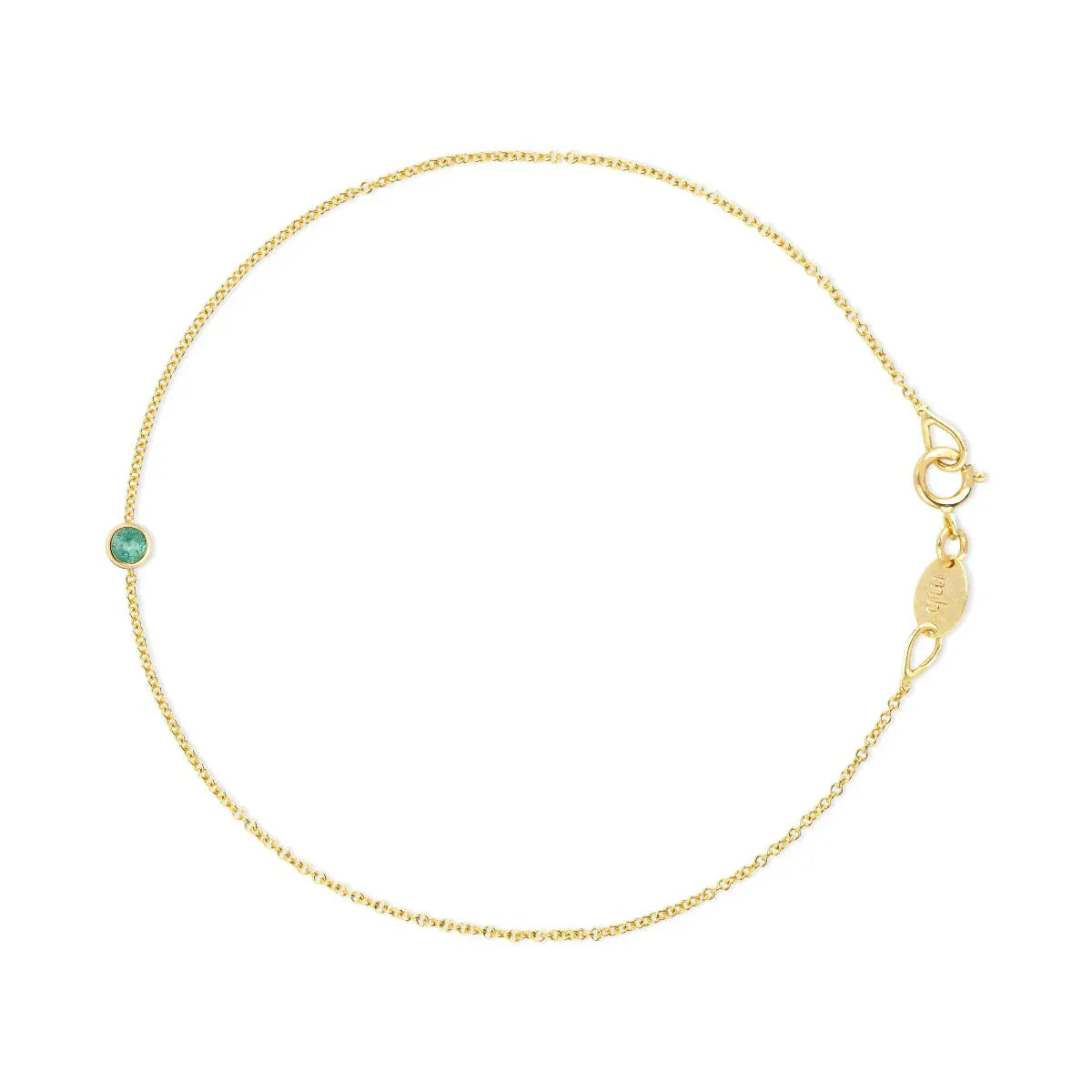 A yellow gold Birthstone Bracelet with a cable chain and an emerald birthstone on a white background. 